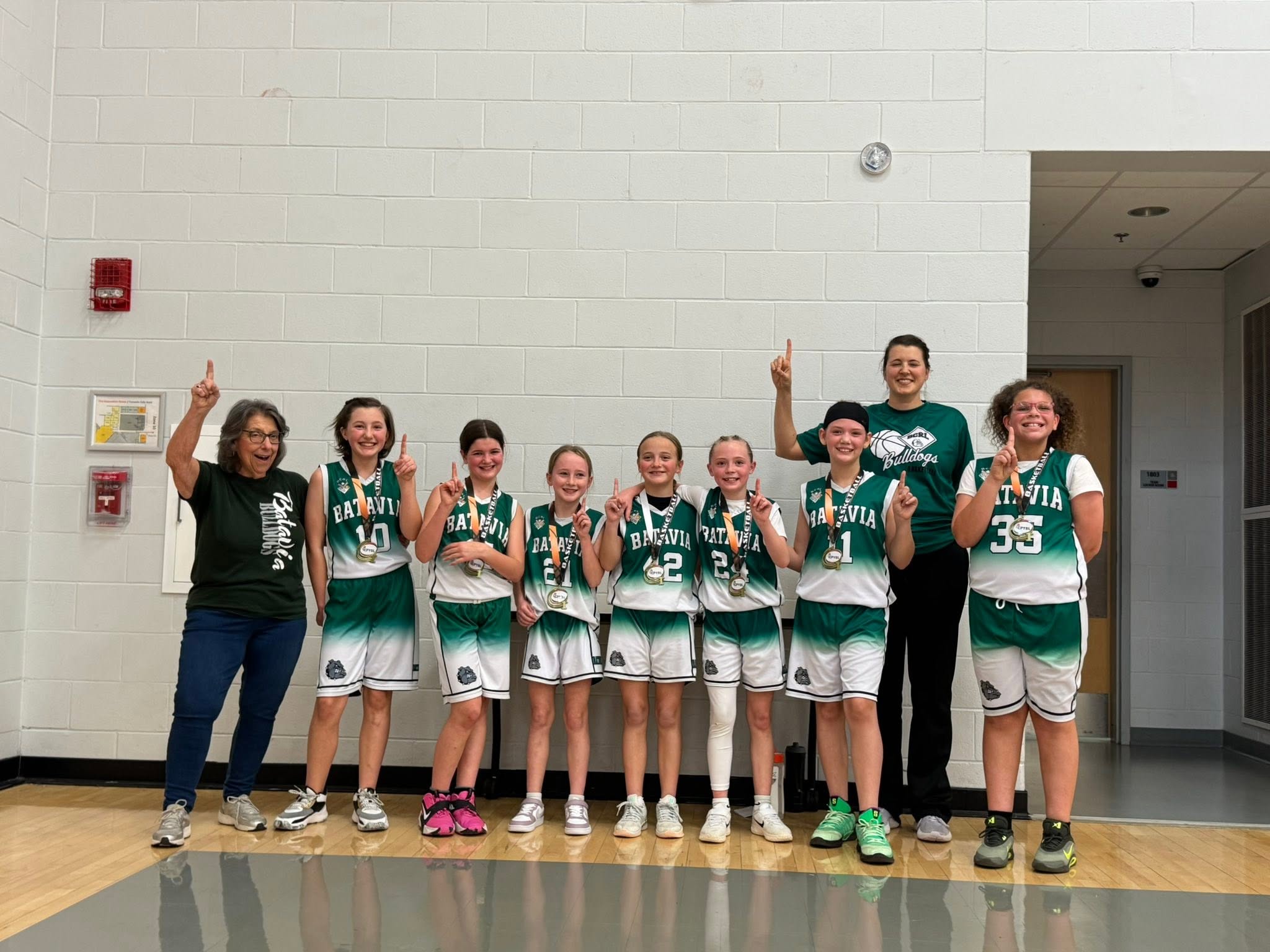 BCRL girls basketball team celebrating with their coaches